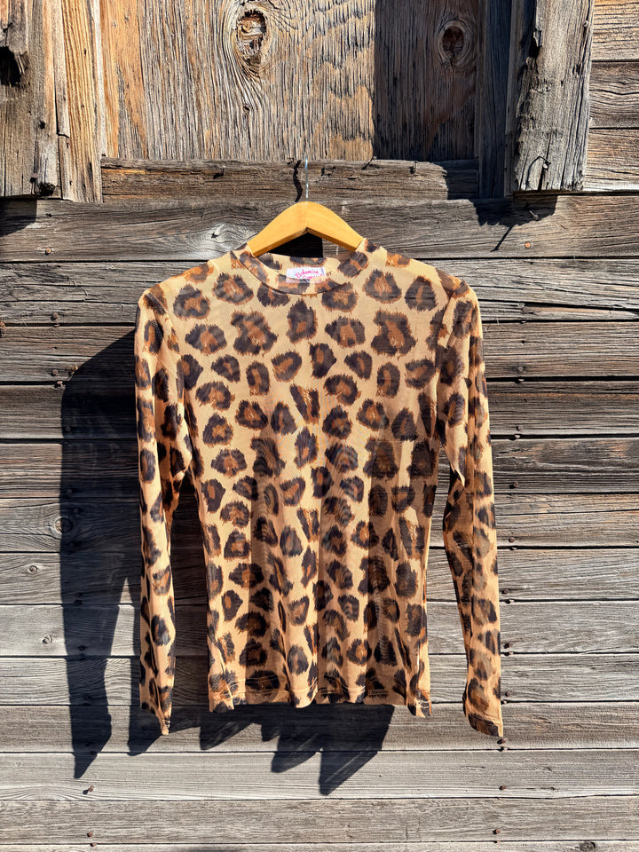 Leopard print mesh shirt on a wooden surface