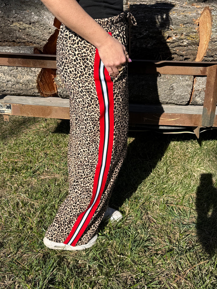 The Penelope Pants - all-over leopard print with a bold red contrast side panel, wide leg, elastic waistband.
