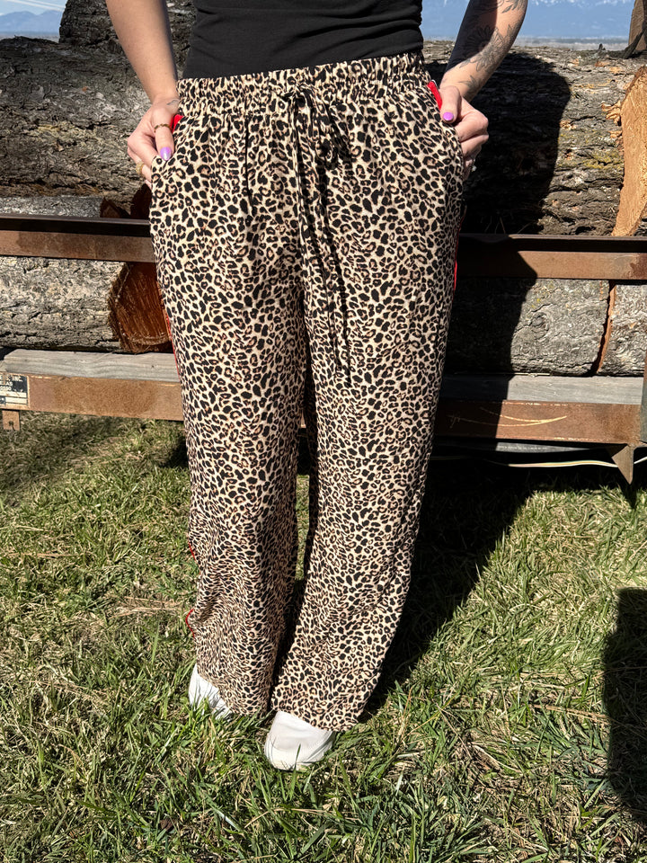 The Penelope Pants - all-over leopard print with a bold red contrast side panel, wide leg, elastic waistband.