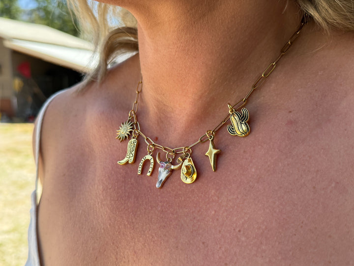 model wearing gold charm paperclip necklace western themed