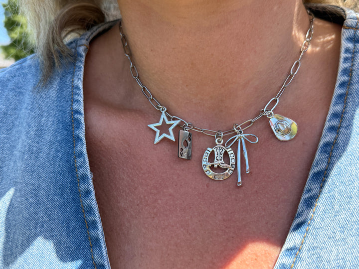 model wearing silver charm paperclip necklace western themed