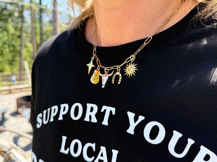model wearing gold charm paperclip necklace western themed