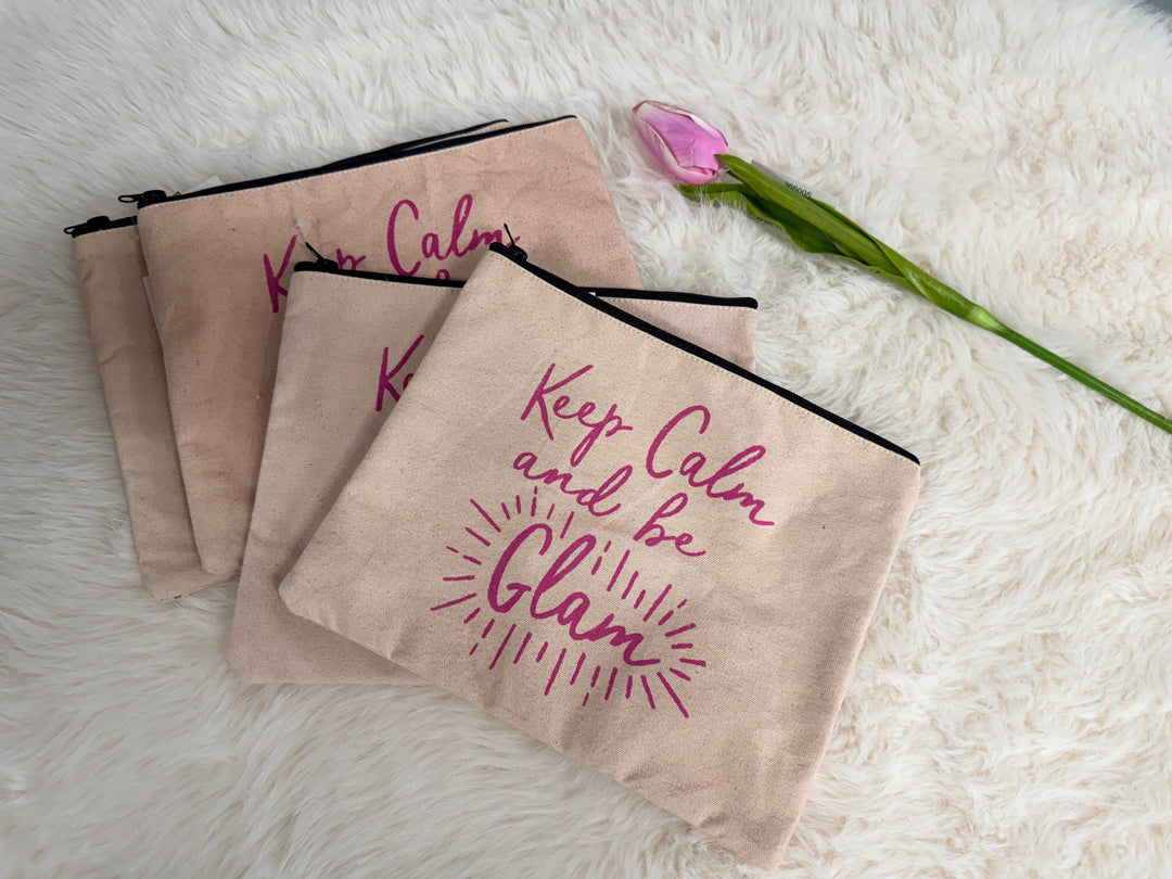 'Keep Calm and be Glam' text on a white fluffy surface with a tulip.