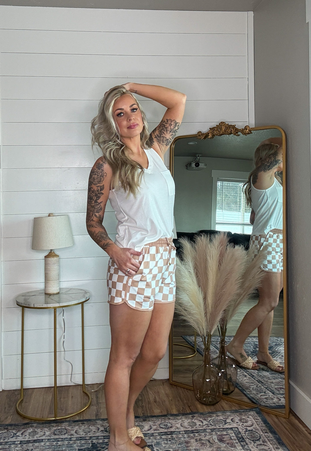 The Checkmate Shorts - mid-rise,  tie waist drawstring for adjustability, and side pockets for convenience,  relaxed fit. neutral checkered print
