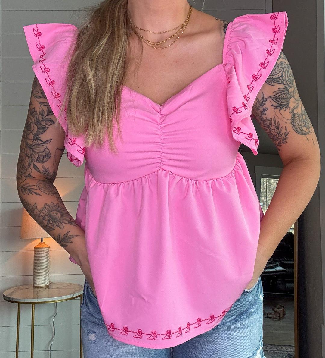 The Brielle Blouse - Pink top with embroidered cowboy boots and bow tie in the back 