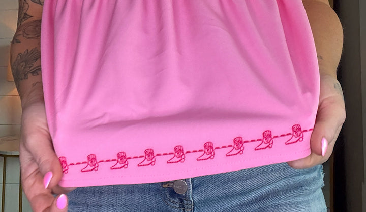 The Brielle Blouse - Pink top with embroidered cowboy boots and bow tie in the back 