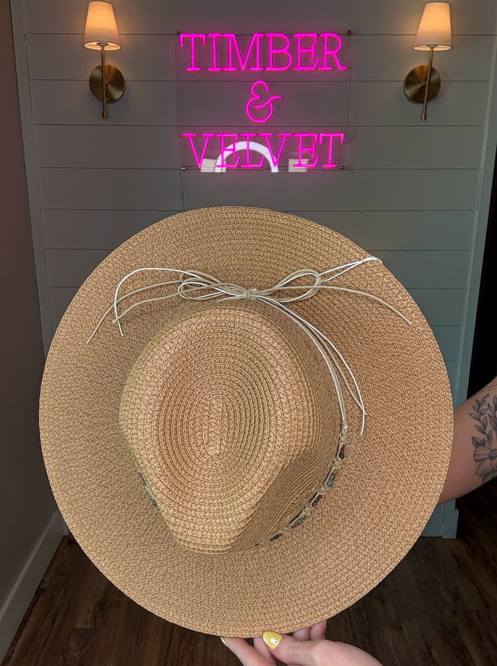 woven cowboy sun hat with beaded detailing and bow tie in the back. 