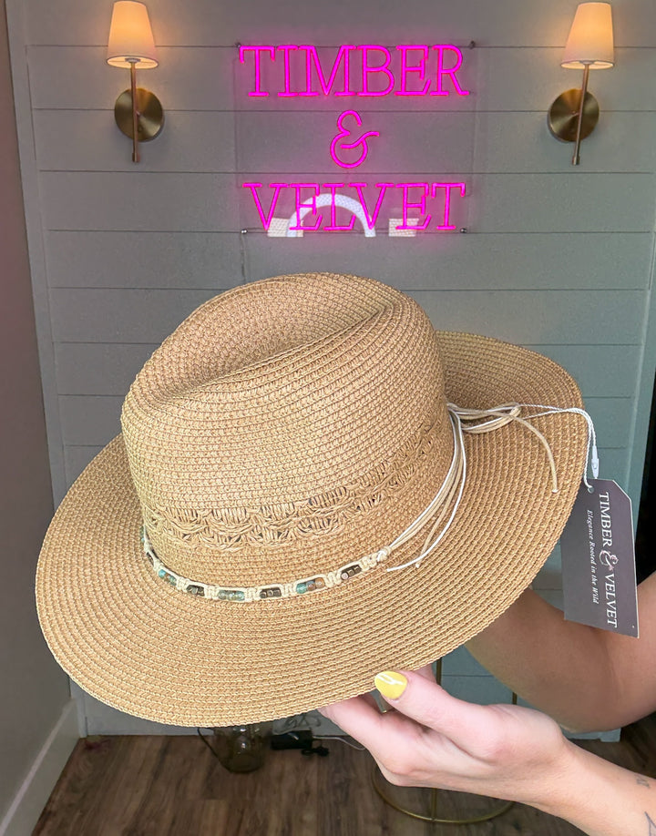 woven cowboy sun hat with beaded detailing and bow tie in the back. 