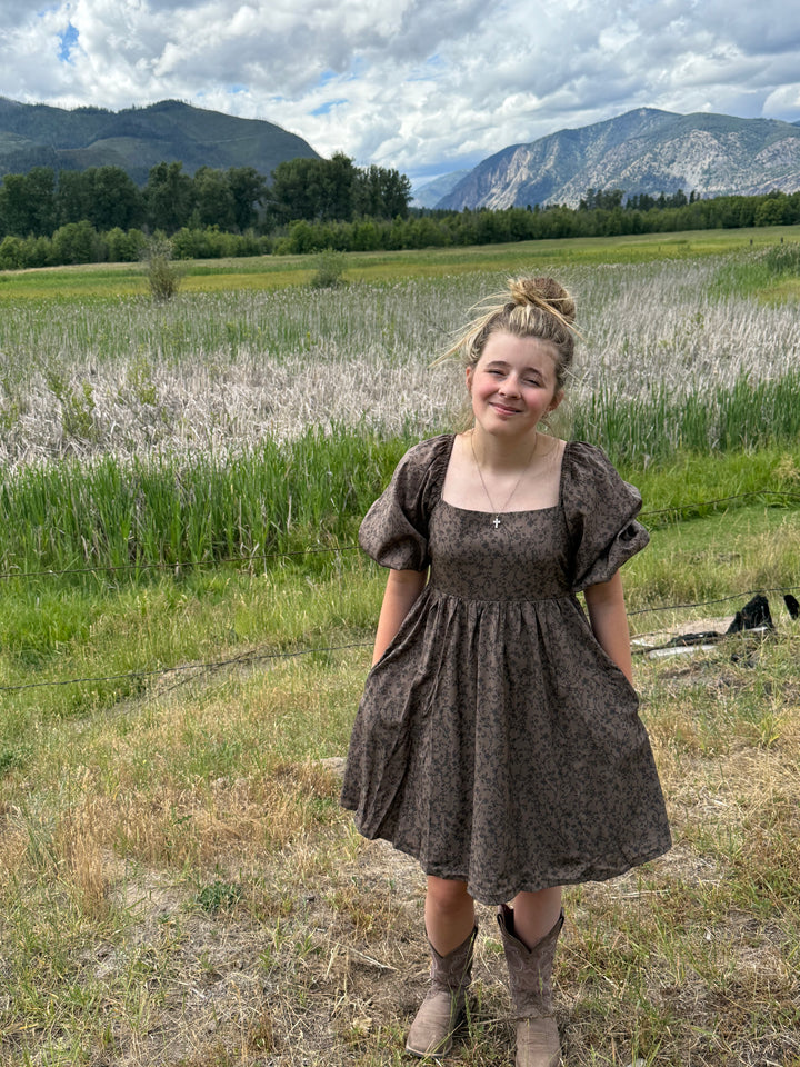 person wearing a Floral dress with puff sleeves and square neckline in chocolate 