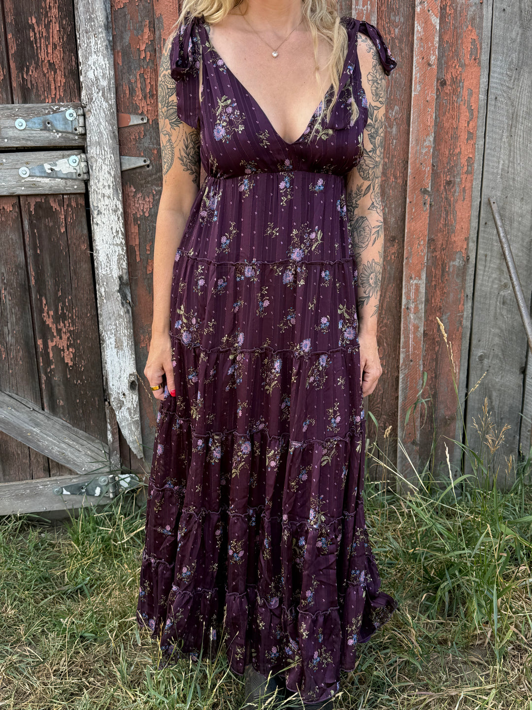 Person wearing a purple floral dress 