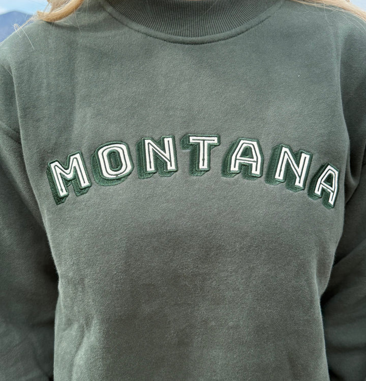 Green sweatshirt with 'MONTANA' text on a person wearing it.