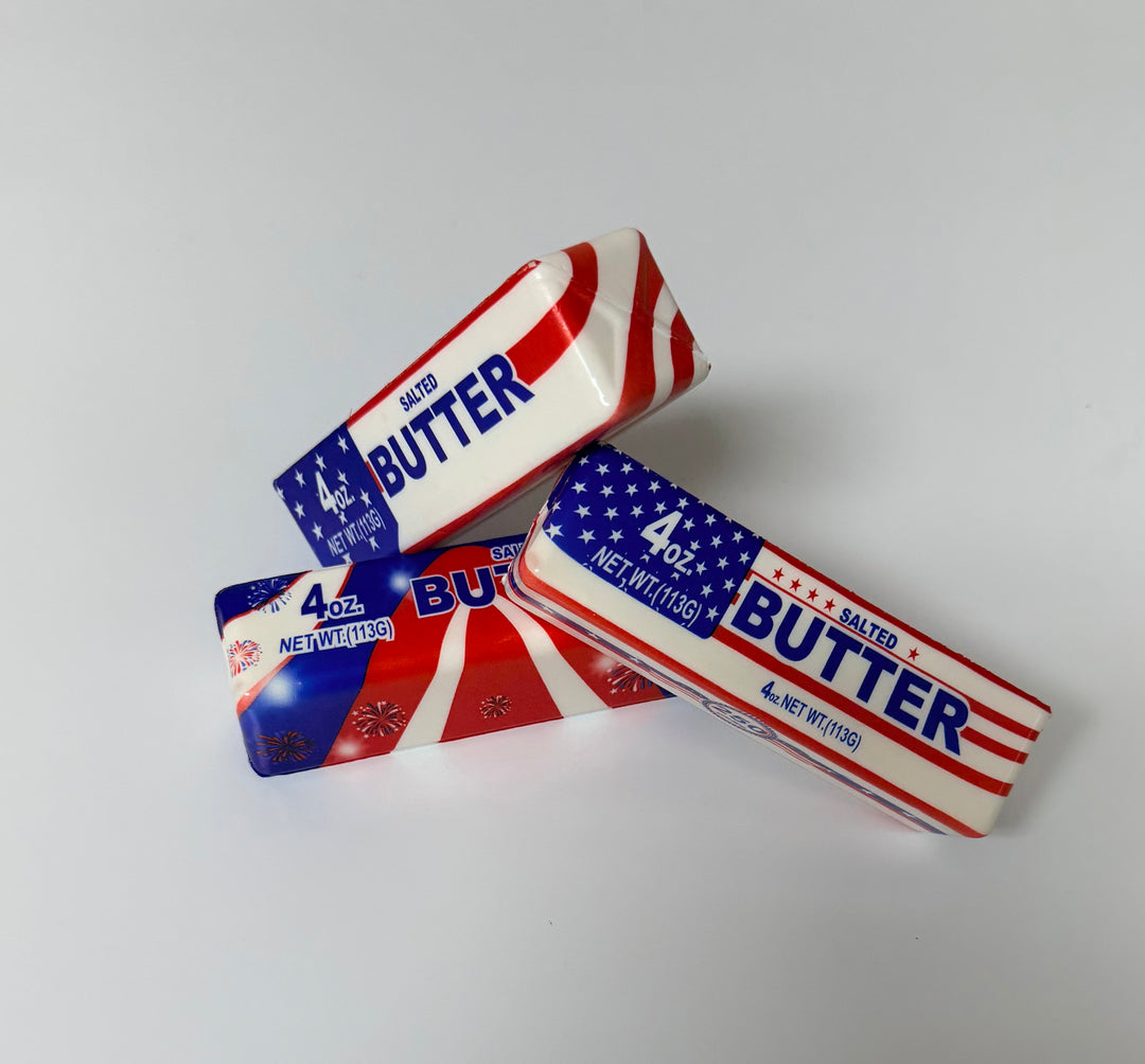 Three packages of 'Butter' squishy with American flag design on a white background