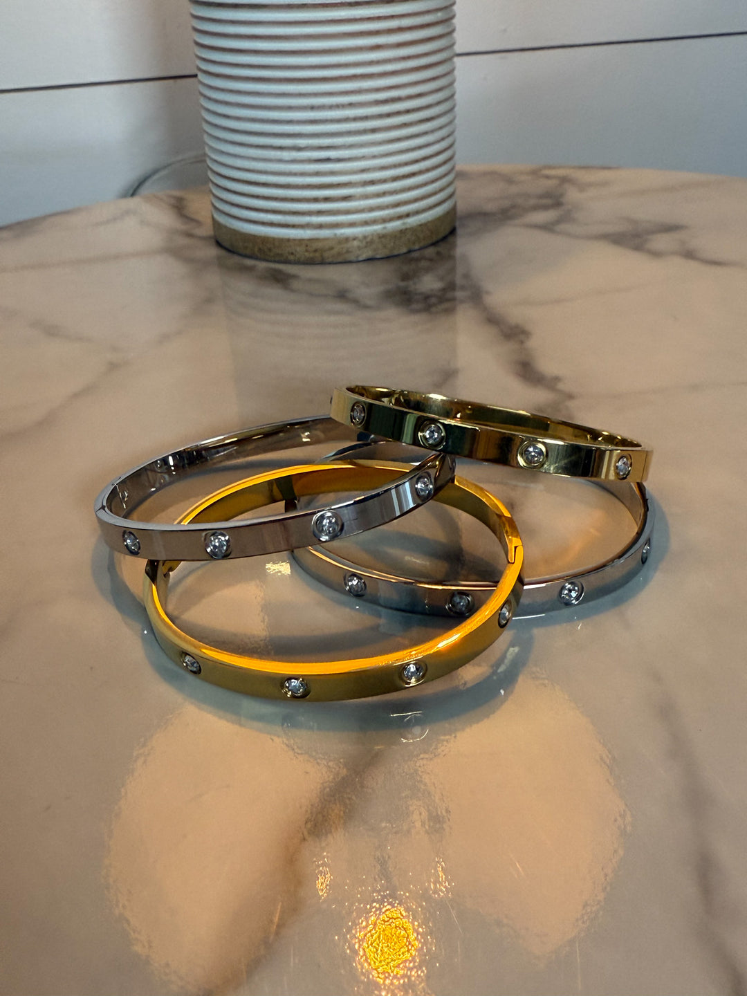 The Luxe Radiance Bangle - hinged bracelet is adorned with sparkling, bezel-set stones