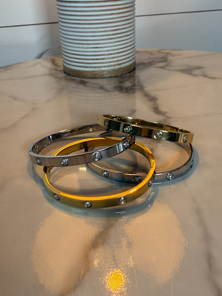 The Luxe Radiance Bangle - hinged bracelet is adorned with sparkling, bezel-set stones