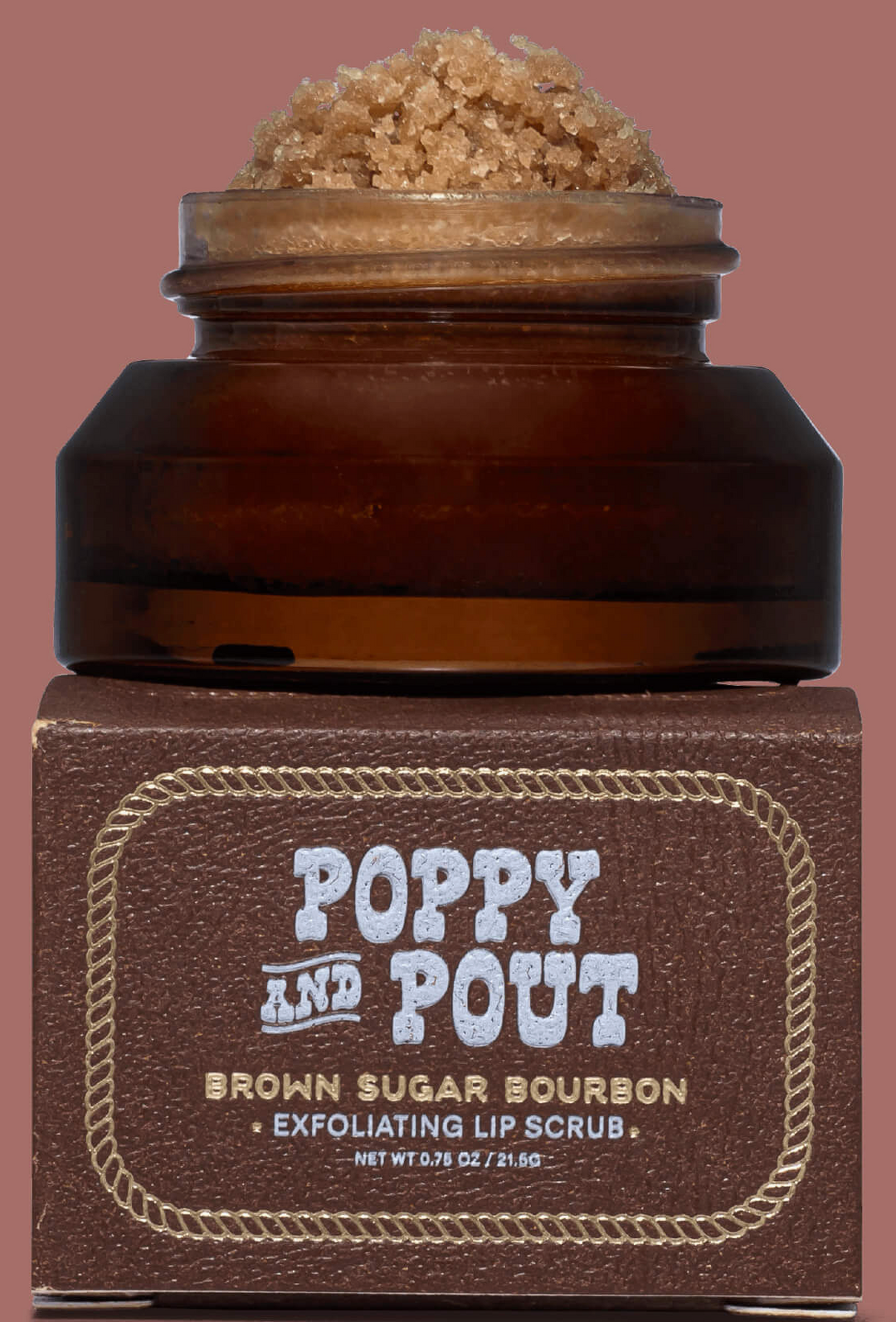 Brown sugar bourbon exfoliating lip scrub with 'Poppy and Pout' branding on a brown background